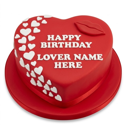 Red heart-shaped birthday cake with white hearts and red lips decoration, featuring a custom message.