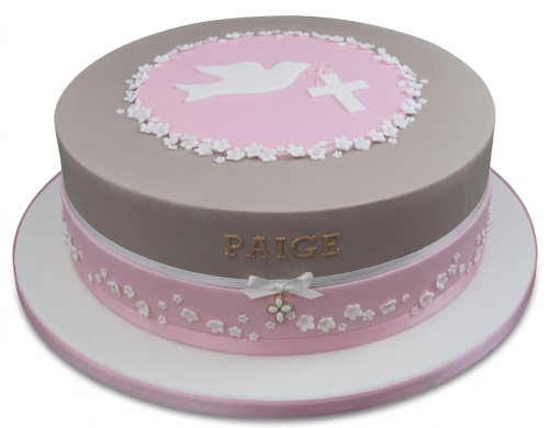 Round Christening cake for girls with white dove, cross, and pink floral decorations.