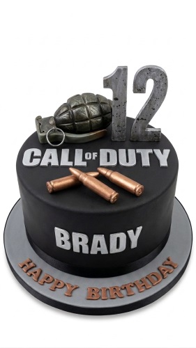 Black Call of Duty themed birthday cake with grenade, bullets, and custom age topper.
