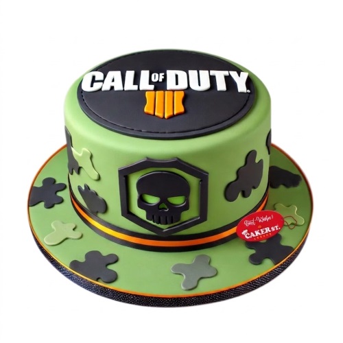 Round green Call of Duty Black Ops 4 birthday cake with black skull emblem and camouflage.