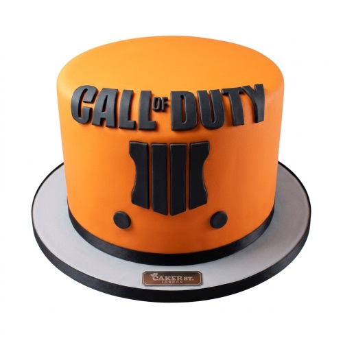 Round orange cake with black 'Call of Duty' text and game logo on the side.