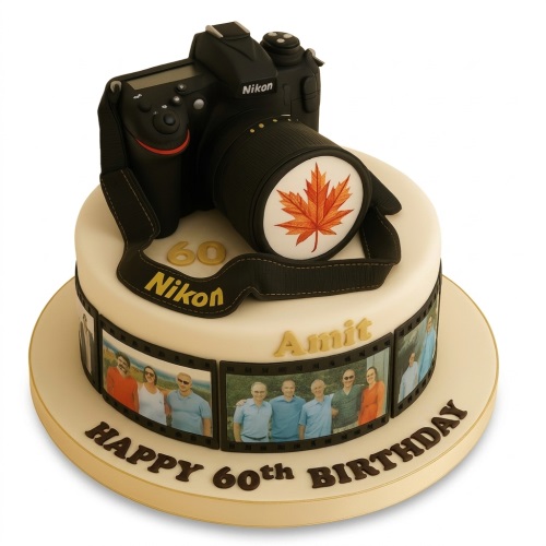 Round white birthday cake with a black camera, maple leaf, and edible photo strips.