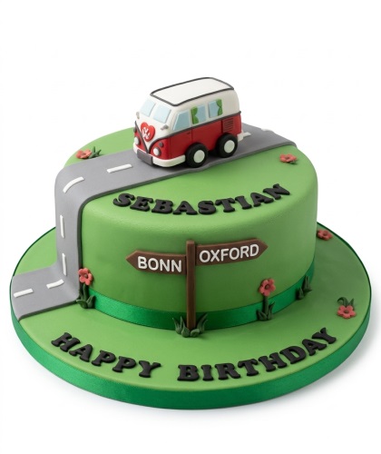 Round green birthday cake with a red and white camper van, grey road, and brown signpost with customisable destinations.