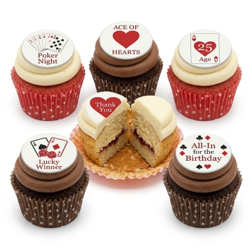 A set of casino and poker themed cupcakes with edible toppers, including playing cards, dice, and card suits. Some have chocolate frosting and brown cases, others have cream frosting and red cases. One cupcake is cut in half, revealing a jam filling.