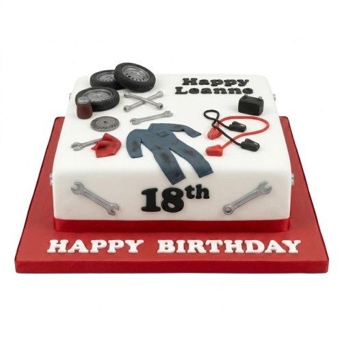 Square white mechanic theme birthday cake with fondant tools, tires, jumpsuit, and custom age.
