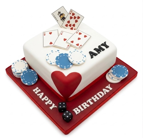 White square birthday cake with red base, decorated with playing cards, blue poker chips, red heart, and black dice. Personalised name and 'Happy Birthday' message visible.