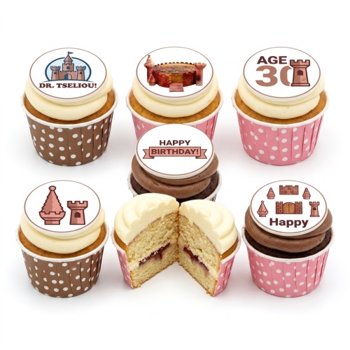 A selection of castle-themed birthday cupcakes with custom age and message toppers, in brown and pink polka dot wrappers.