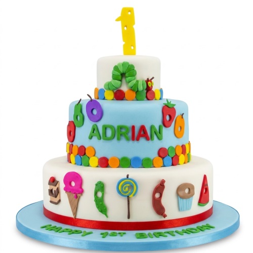 Three-tier The Very Hungry Caterpillar 1st birthday cake with a yellow '1' topper and a personalised name.