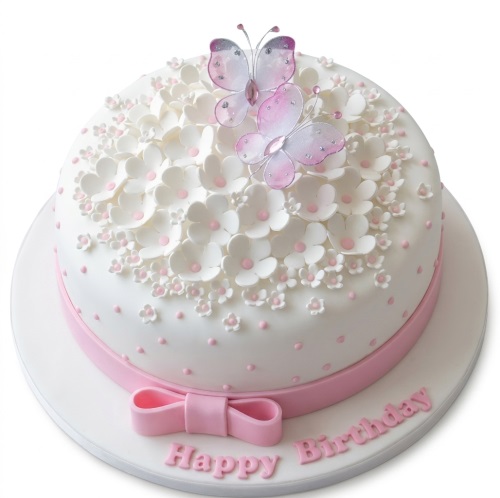 Round white cake with pink floral decorations, two butterflies, and a pink bow.
