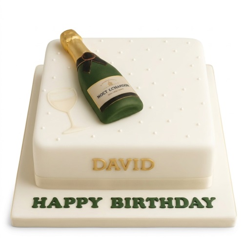 Two-tiered white square cake with an edible green and gold champagne bottle and a white champagne glass outline, with 'Happy Birthday' written on the base.