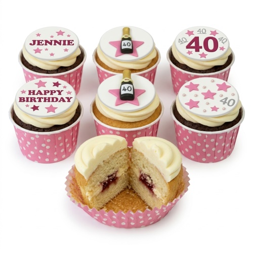 Six cupcakes with white frosting, pink polka dot cases, star decorations, and custom age/message toppers.