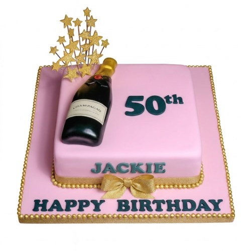 Two-tiered pink birthday cake with edible champagne bottle, gold stars, and gold trim.
