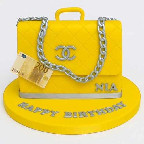 Yellow designer handbag birthday cake with silver chain and logo, 'Happy Birthday' message.