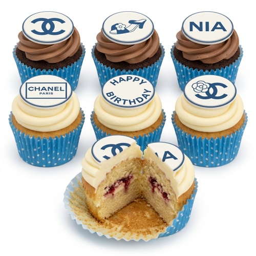 Assortment of Chanel inspired cupcakes with chocolate and vanilla frosting, blue polka dot cases, and edible toppers.
