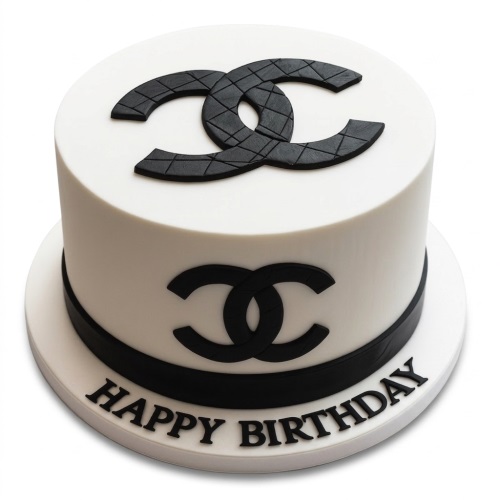 White round cake with black Chanel logos and 'Happy Birthday' message on the board.