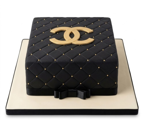 Black quilted square cake with gold interlocking CC logo, gold studs, and a black ribbon bow.