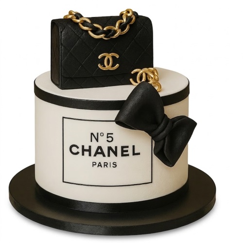 Two-tier white and black Chanel N°5 designer birthday cake with a black quilted handbag and gold chain on top.