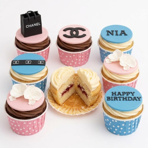 Collection of Chanel theme cupcakes with shopping bag, logo, flowers, and custom birthday message.
