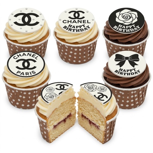 Chanel-inspired cupcakes with black and white logo, rose, and bow toppers, some with 'Happy Birthday' text.