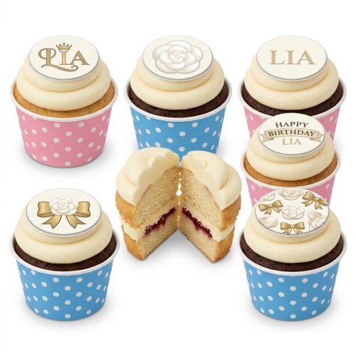 Elegant birthday cupcakes with white frosting, floral and bow toppers, in pink and blue polka dot wrappers.