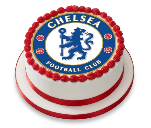 Round white cake with a large edible Chelsea Football Club logo on top, bordered by red piped icing and a red ribbon around the base.