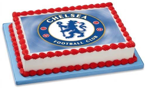 Rectangular white cake with Chelsea Football Club logo edible image and red piped shell borders on a blue board.