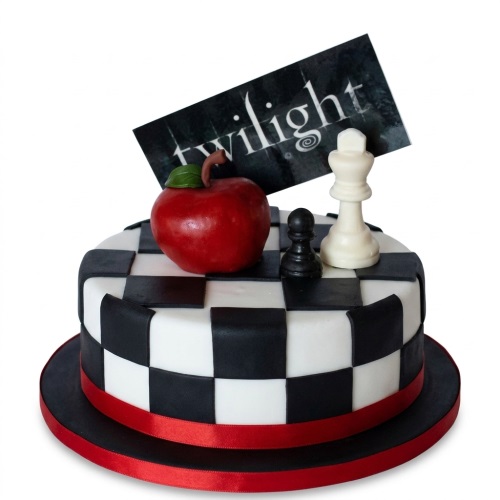 Round Twilight theme birthday cake with black and white chessboard, red apple, and chess pieces.