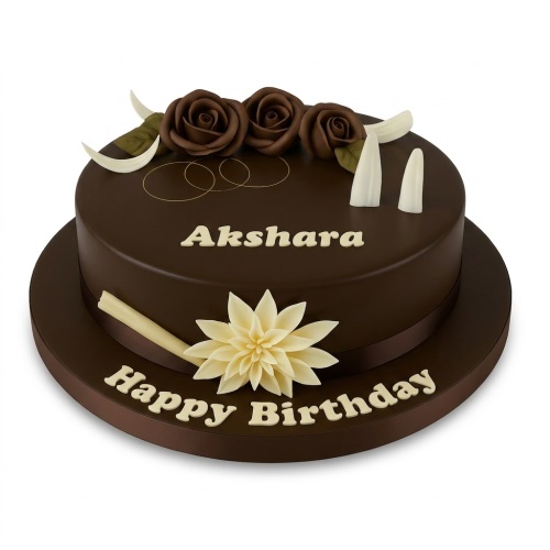 Round dark brown cake with dark chocolate roses, white chocolate curls, and a large cream flower.