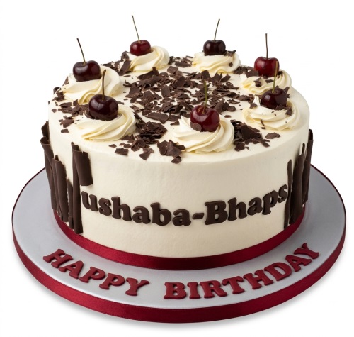 Round cream cake with chocolate shavings, chocolate curls, and fresh cherries, with a 'Happy Birthday' message.