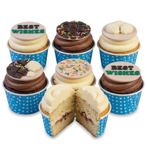 Assortment of celebration cupcakes with "Best Wishes" toppers, sprinkles, chocolate weave, and shell decorations.