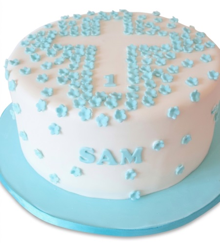 Round white Christening cake with blue floral cross and custom name