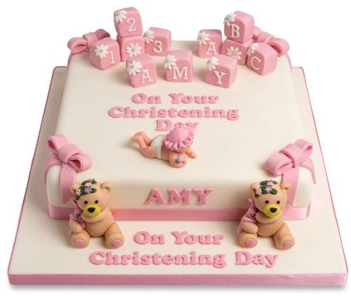 Two-tier white and pink Christening cake for a girl, decorated with baby blocks, a baby figure, teddy bears, and pink bows.