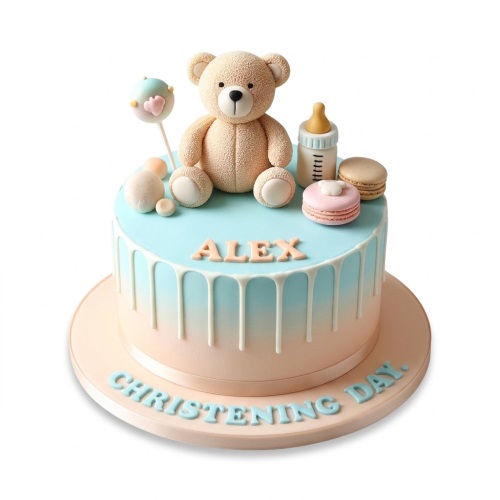 Round christening cake with blue and peach ombre, white drip, 3D teddy bear, baby bottle, macarons, and a cake pop.