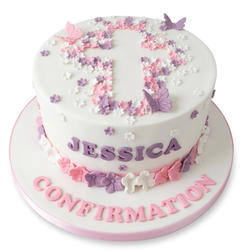 White round Confirmation cake with a floral cross design, pink and purple flowers, and butterflies.