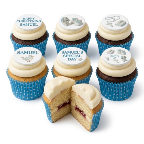 Assortment of white and chocolate cupcakes with white frosting and blue-themed Christening toppers including baby items and religious symbols.
