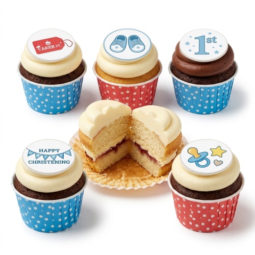 White Christening cupcakes with blue baby booties, cross, dummy, and "Happy Christening" message.