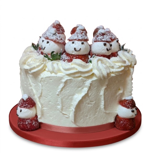 Round white cream cake decorated with strawberry snowmen, green leaves, and a red ribbon on a red board.