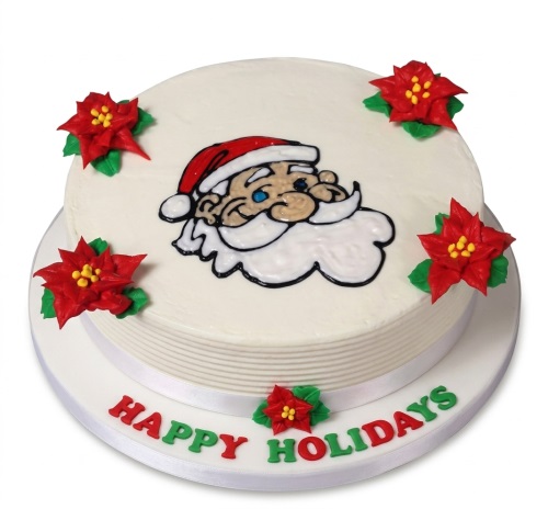Round white Christmas cake with Santa Claus face and red poinsettia decorations.