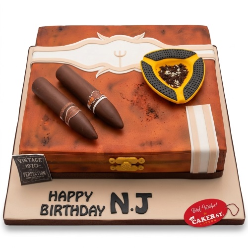 Rectangular cigar box cake with two edible cigars, an ashtray, and a vintage plaque.