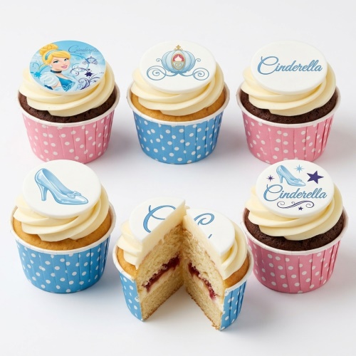 Cinderella themed cupcakes with character, carriage, and glass slipper toppers on pink and blue polka dot cases.
