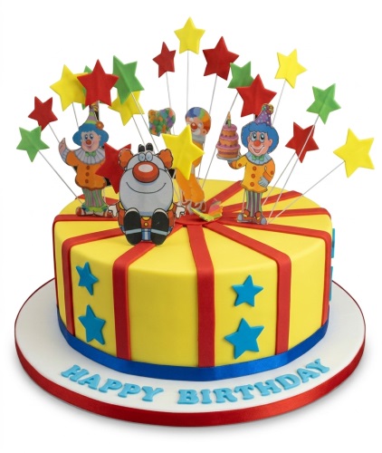 Yellow birthday cake with clown figures, colourful star toppers, and blue star decorations.