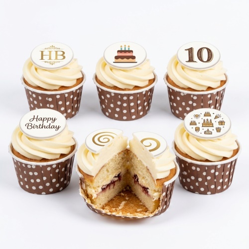 Birthday cupcakes with cream frosting, brown polka dot wrappers, and customisable edible toppers.