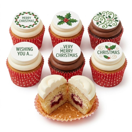Six Christmas cupcakes with holly and wreath toppers, some with "Merry Christmas" text, in red polka dot cases. One cupcake is cut open showing a jam filling.