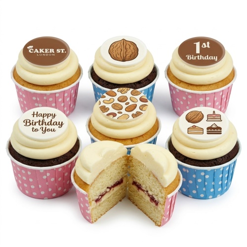 Round cupcakes covered entirely with chopped walnuts on a dark cupcakes board.