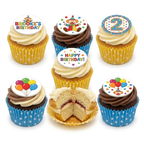 Assortment of vanilla and chocolate cupcakes with clown, balloon, and 'Happy Birthday' toppers, some with custom age '2' and 'Brooke's Birthday'.