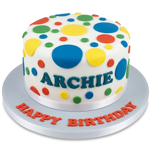 Round white cake with colourful blue, yellow, red, and green polka dots and a personalised message.