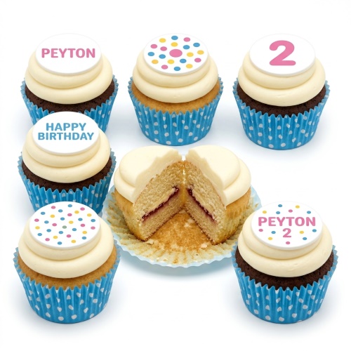Assortment of polka dot birthday cupcakes with white frosting, some with custom name, age, and 'Happy Birthday' toppers.