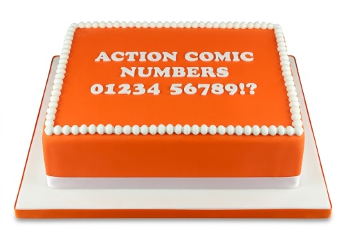 Bright orange square cake with white edible pearls and 'ACTION COMIC NUMBERS 01234 56789!?' text.