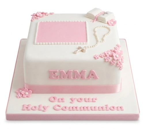 White square cake with pink ribbon, rosary, bible, and pink flowers