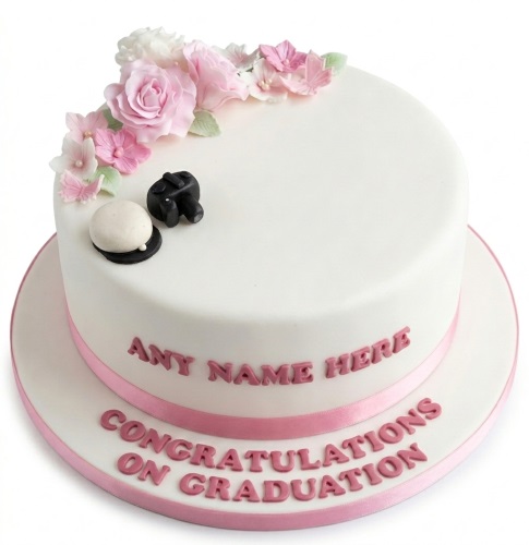 White round graduation cake with pink sugar flowers, graduation cap, and personalised message.